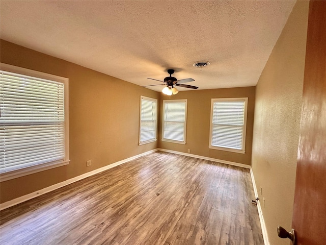 213 W Tennie St, Gainesville, TX 76240 - unfurnished room featuring wood finished floors, ceiling fan, baseboards, and a textured ceiling