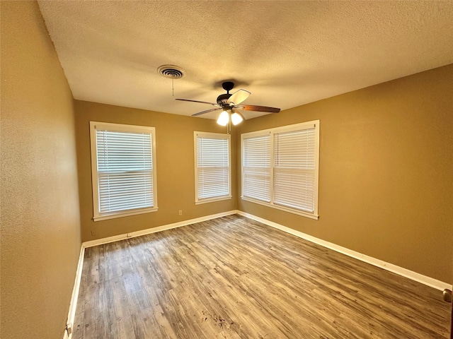 213 W Tennie St, Gainesville, TX 76240 - unfurnished room featuring a ceiling fan, wood finished floors, baseboards, and a textured ceiling