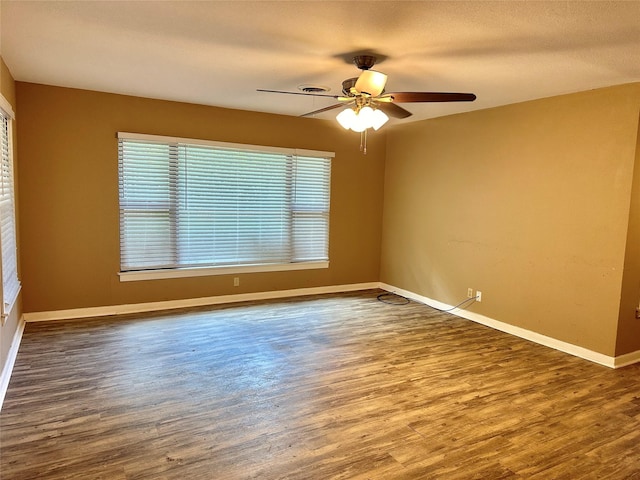213 W Tennie St, Gainesville, TX 76240 - spare room with ceiling fan, wood finished floors, and baseboards