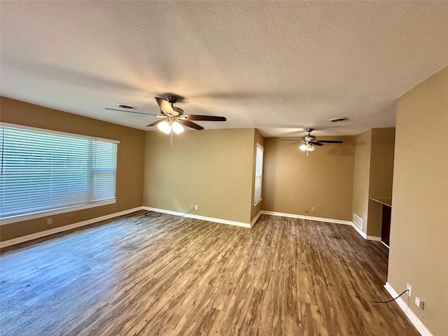 213 W Tennie St, Gainesville, TX 76240 - unfurnished room with a ceiling fan, wood finished floors, a textured ceiling, and baseboards