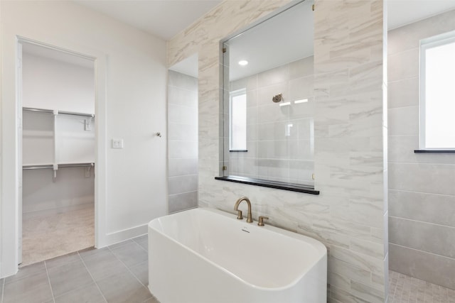 4160 Rosita Ln, Prosper, TX 75078 - bathroom with a freestanding bath, tile patterned flooring, a walk in shower, a spacious closet, and tile walls