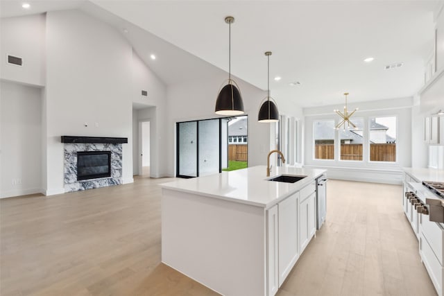 4160 Rosita Ln, Prosper, TX 75078 - kitchen with a sink, light wood-style floors, dishwasher, white cabinetry, and a chandelier