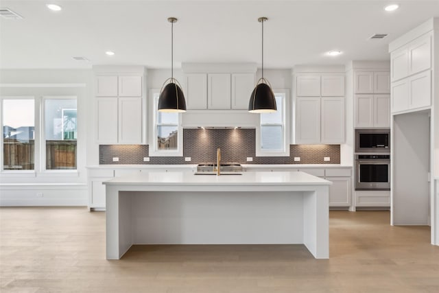 4160 Rosita Ln, Prosper, TX 75078 - kitchen with appliances with stainless steel finishes, light countertops, backsplash, a kitchen island with sink, and recessed lighting