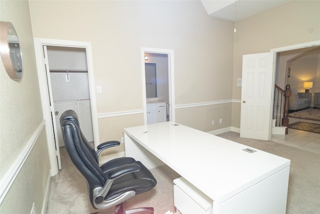 home office featuring light carpet and a high ceiling