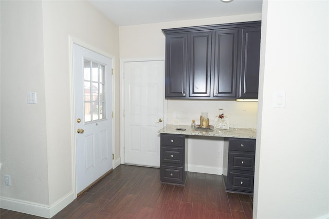 bar with dark wood-style floors and baseboards