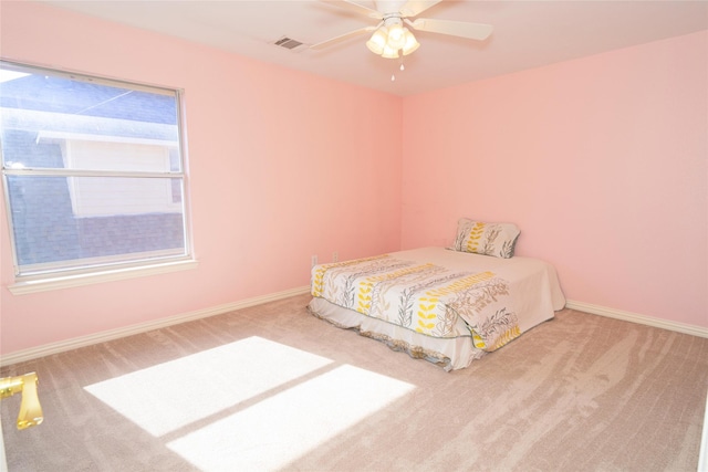 carpeted bedroom with baseboards and a ceiling fan