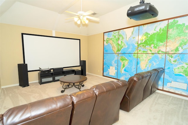 cinema with light colored carpet, ceiling fan, baseboards, and vaulted ceiling