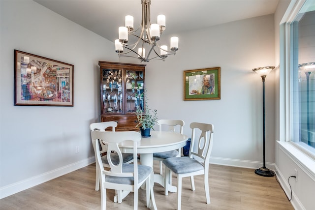 6628 Kort St, Rowlett, TX 75089 - dining room with light wood-style floors, a chandelier, and baseboards