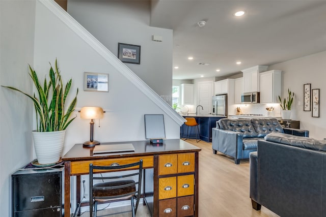 6628 Kort St, Rowlett, TX 75089 - home office with light wood-style flooring, recessed lighting, and a sink