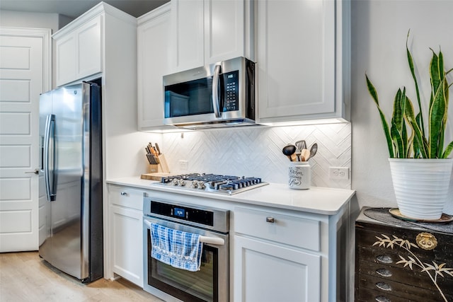6628 Kort St, Rowlett, TX 75089 - kitchen featuring stainless steel appliances, light countertops, backsplash, white cabinetry, and light wood finished floors