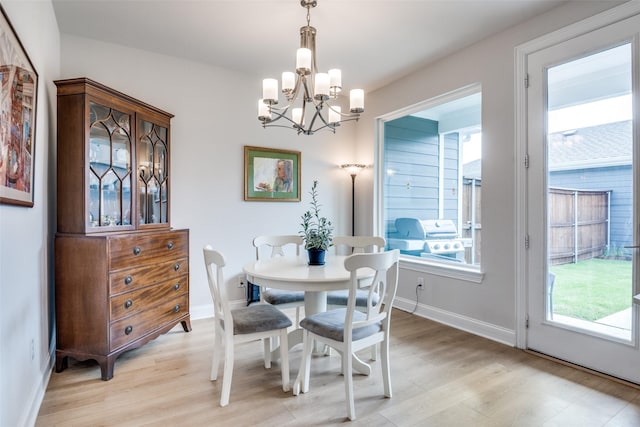 6628 Kort St, Rowlett, TX 75089 - dining room featuring a chandelier, light wood finished floors, and baseboards