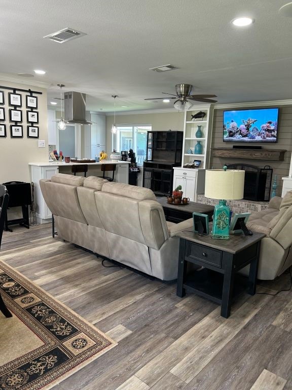 5004 Blackstone Dr, River Oaks, TX 76114 - living room featuring light wood-style flooring, recessed lighting, ceiling fan, and a textured ceiling
