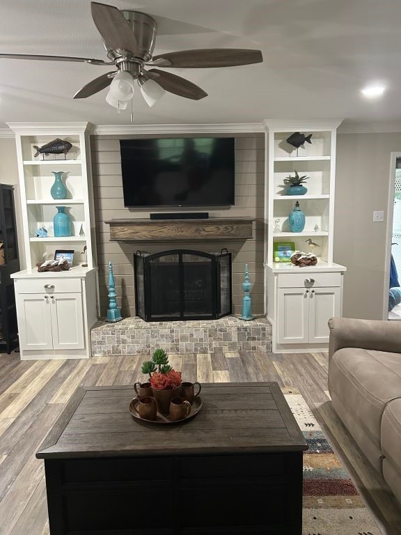 5004 Blackstone Dr, River Oaks, TX 76114 - living area featuring ornamental molding, light wood-style floors, a brick fireplace, and ceiling fan