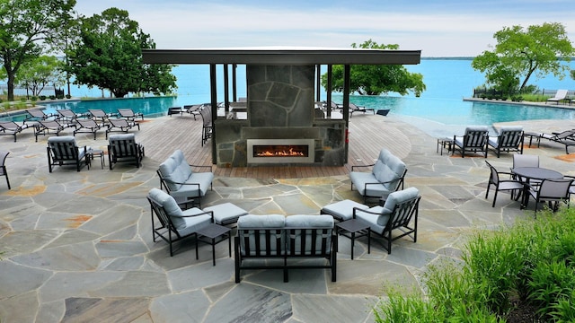 view of patio / terrace featuring an outdoor living space, a community pool, and a wooden deck