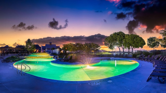 community pool with a patio and fence