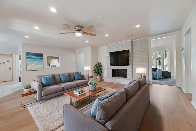 2508 Oak Manor Ct, Arlington, TX 76012 - living room with light wood finished floors, ceiling fan, recessed lighting, and a fireplace