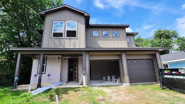2705 12th St, Fort Worth, TX 76111 - view of front of property with board and batten siding, a garage, and driveway