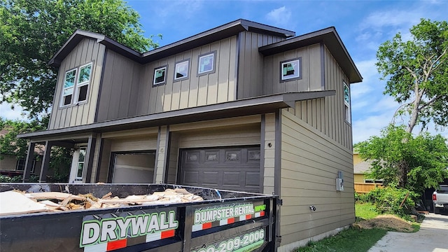 2705 12th St, Fort Worth, TX 76111 - view of home's exterior featuring board and batten siding and an attached garage
