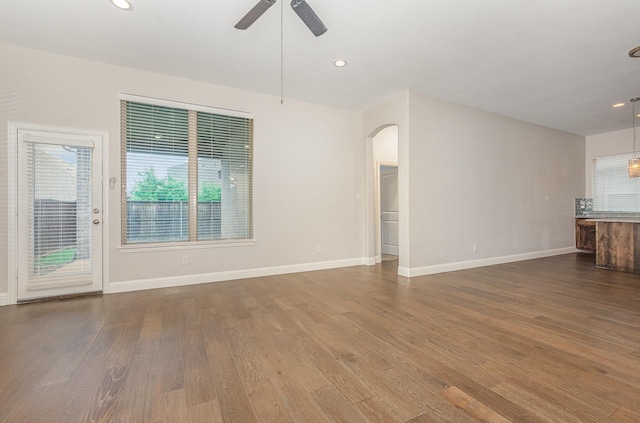 413 Allbright Rd, Celina, TX 75009 - unfurnished living room with arched walkways, dark wood-type flooring, ceiling fan, baseboards, and recessed lighting