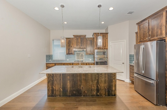 413 Allbright Rd, Celina, TX 75009 - kitchen with appliances with stainless steel finishes, decorative backsplash, light stone counters, light wood finished floors, and recessed lighting