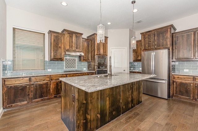 413 Allbright Rd, Celina, TX 75009 - kitchen featuring appliances with stainless steel finishes, dark wood finished floors, under cabinet range hood, backsplash, and light stone counters