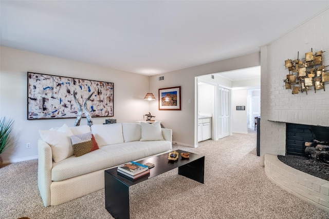 carpeted living area featuring a fireplace and baseboards