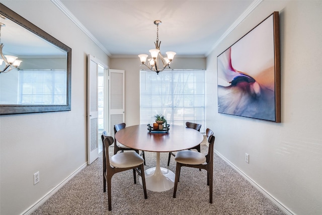 dining room featuring a chandelier, carpet, ornamental molding, and baseboards