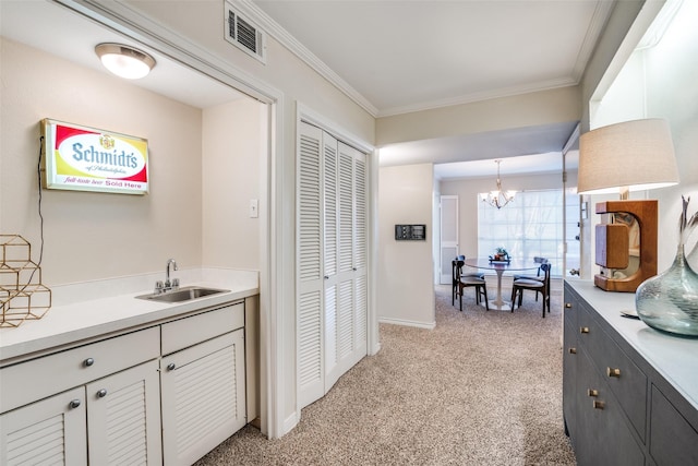 bathroom with a chandelier, ornamental molding, baseboards, a closet, and vanity