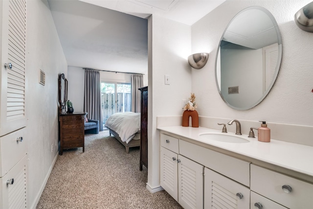 bathroom featuring baseboards, vanity, and connected bathroom