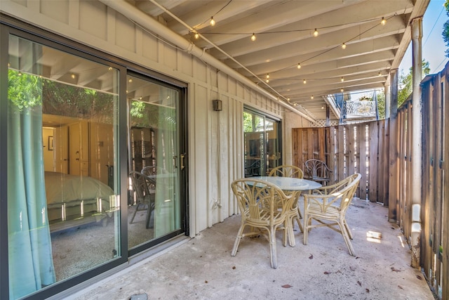 view of patio with fence and outdoor dining space