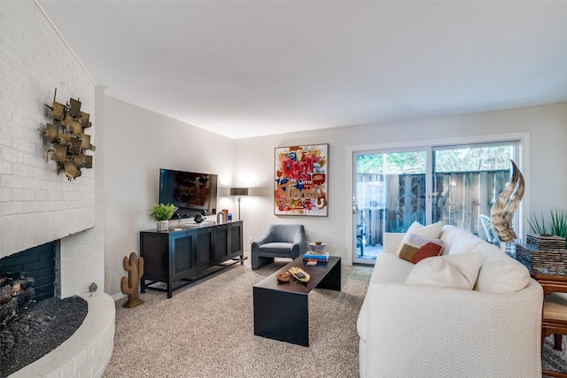 carpeted living room with a brick fireplace