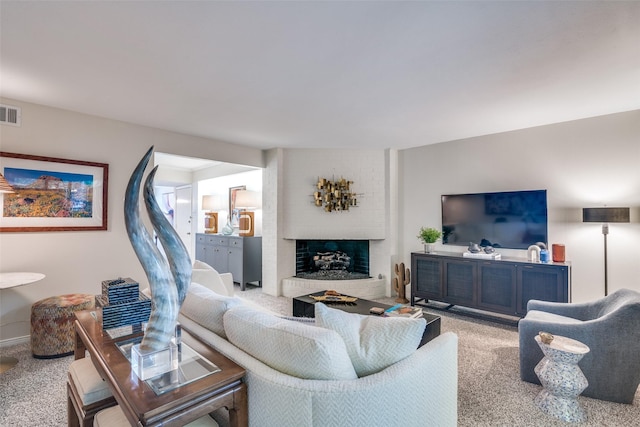 living room with light colored carpet, a fireplace, and baseboards