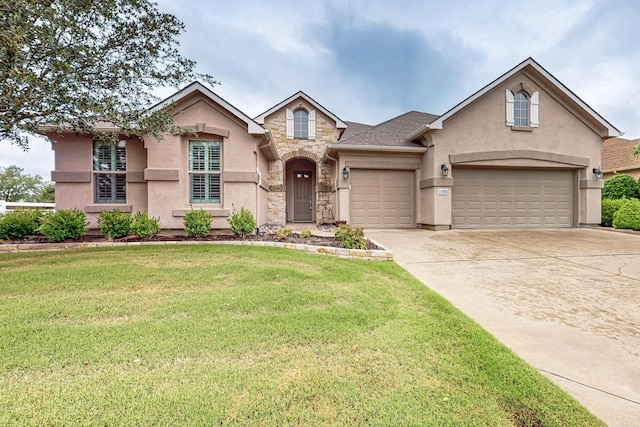 11908 Glenbrook St, Denton, TX 76207 - traditional-style house with stucco siding, stone siding, a front yard, and concrete driveway