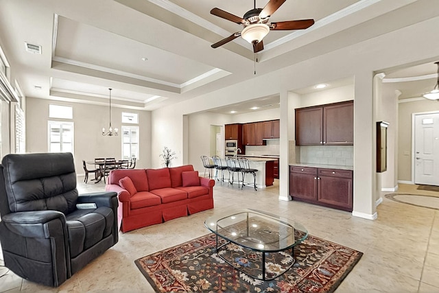 11908 Glenbrook St, Denton, TX 76207 - living area featuring ornamental molding, a ceiling fan, a tray ceiling, a chandelier, and baseboards