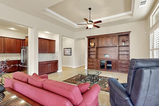 11908 Glenbrook St, Denton, TX 76207 - living room featuring a tray ceiling, a ceiling fan, light tile patterned floors, and baseboards