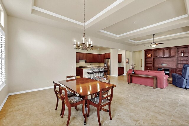 11908 Glenbrook St, Denton, TX 76207 - dining room featuring a tray ceiling, a chandelier, baseboards, light tile patterned floors, and ceiling fan