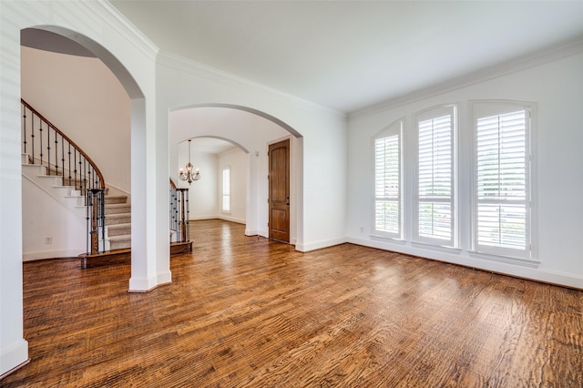 1210 Carlisle Ct, Frisco, TX 75036 - unfurnished living room featuring wood finished floors, ornamental molding, baseboards, stairs, and arched walkways