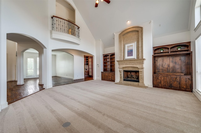 1210 Carlisle Ct, Frisco, TX 75036 - unfurnished living room with high vaulted ceiling, carpet flooring, ceiling fan, baseboards, and a premium fireplace