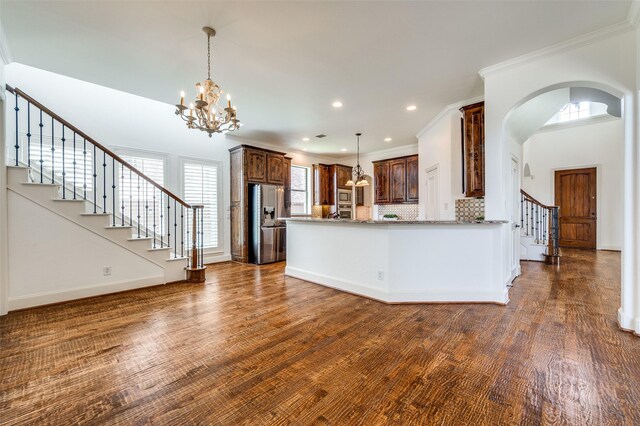 1210 Carlisle Ct, Frisco, TX 75036 - kitchen with appliances with stainless steel finishes, plenty of natural light, arched walkways, a chandelier, and recessed lighting