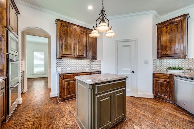 1210 Carlisle Ct, Frisco, TX 75036 - kitchen with stainless steel appliances, ornamental molding, decorative backsplash, baseboards, and light stone countertops