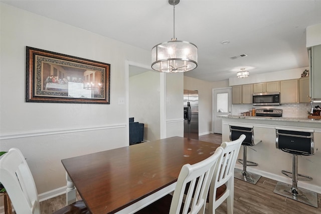 205 Davis Rd, Combine, TX 75159 - dining room with dark wood-style flooring, a chandelier, and baseboards