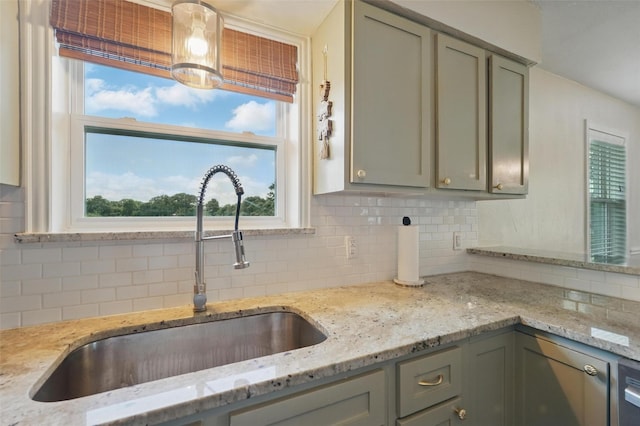 205 Davis Rd, Combine, TX 75159 - kitchen featuring a sink, backsplash, light stone countertops, and gray cabinets