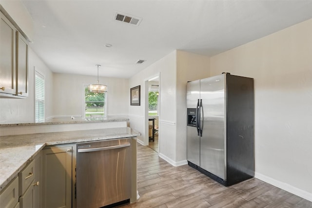 205 Davis Rd, Combine, TX 75159 - kitchen with stainless steel appliances, light wood-style flooring, a peninsula, and baseboards