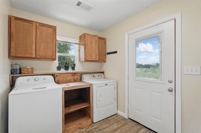 205 Davis Rd, Combine, TX 75159 - laundry room featuring washer and dryer, light wood-style floors, and cabinet space