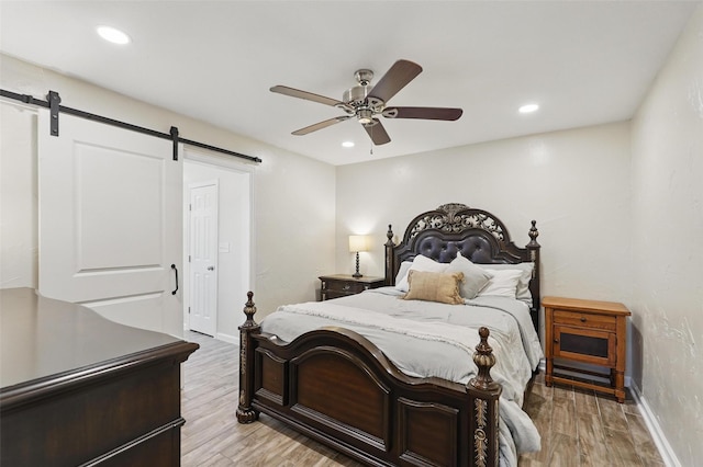 205 Davis Rd, Combine, TX 75159 - bedroom featuring a barn door, baseboards, recessed lighting, light wood-style floors, and ceiling fan