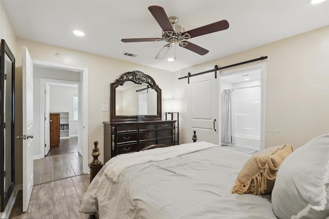 205 Davis Rd, Combine, TX 75159 - bedroom with a barn door, recessed lighting, wood finished floors, a ceiling fan, and baseboards