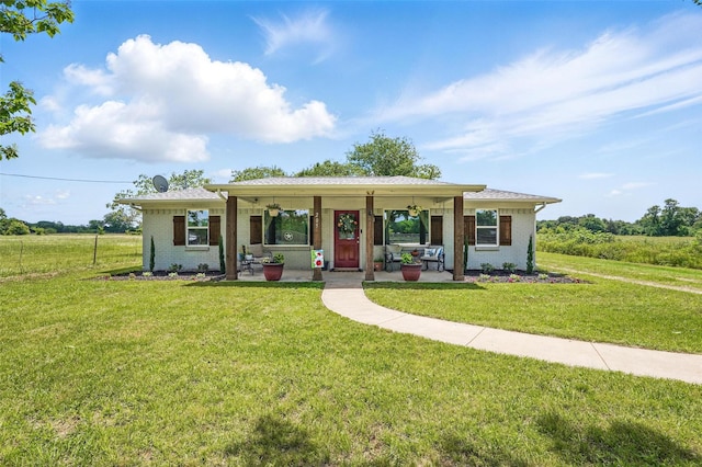 205 Davis Rd, Combine, TX 75159 - ranch-style house with covered porch, a front lawn, and brick siding
