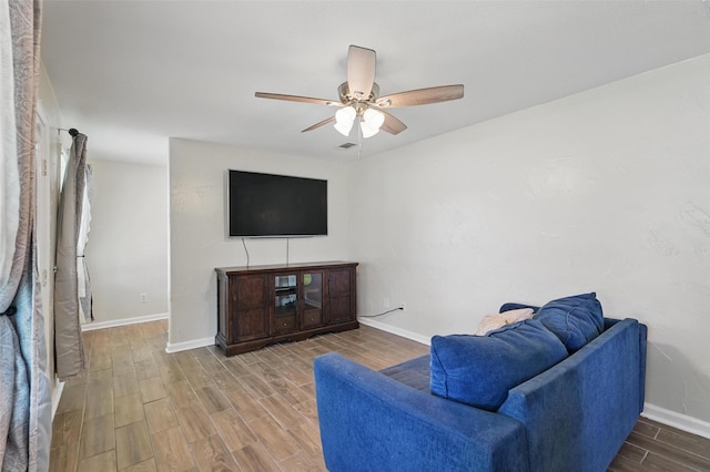 205 Davis Rd, Combine, TX 75159 - living area featuring wood finished floors, ceiling fan, and baseboards