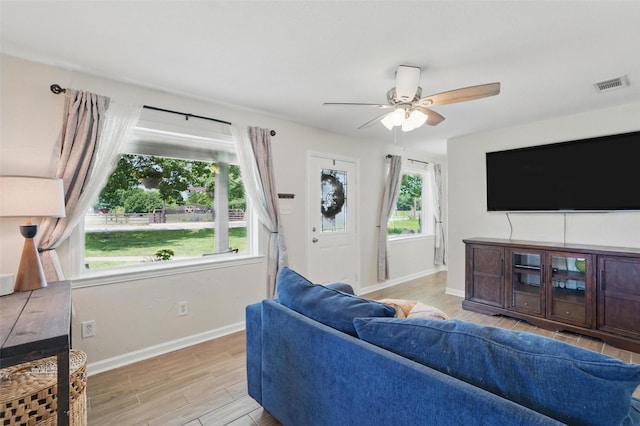 205 Davis Rd, Combine, TX 75159 - living room with light wood-style flooring, baseboards, and a ceiling fan