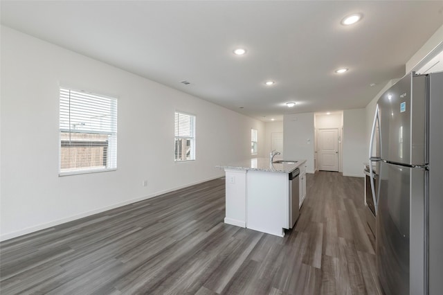6303 Tropicana Ln, Forney, TX 75126 - kitchen featuring appliances with stainless steel finishes, a sink, dark wood-style floors, recessed lighting, and light stone countertops